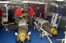 030319-N-4142-G-020-ABOARD-USS-CONSTELLATION-CV-64-March-19-2003-Ordinance-handlers-assemble-b...jpg