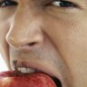 man eating apple